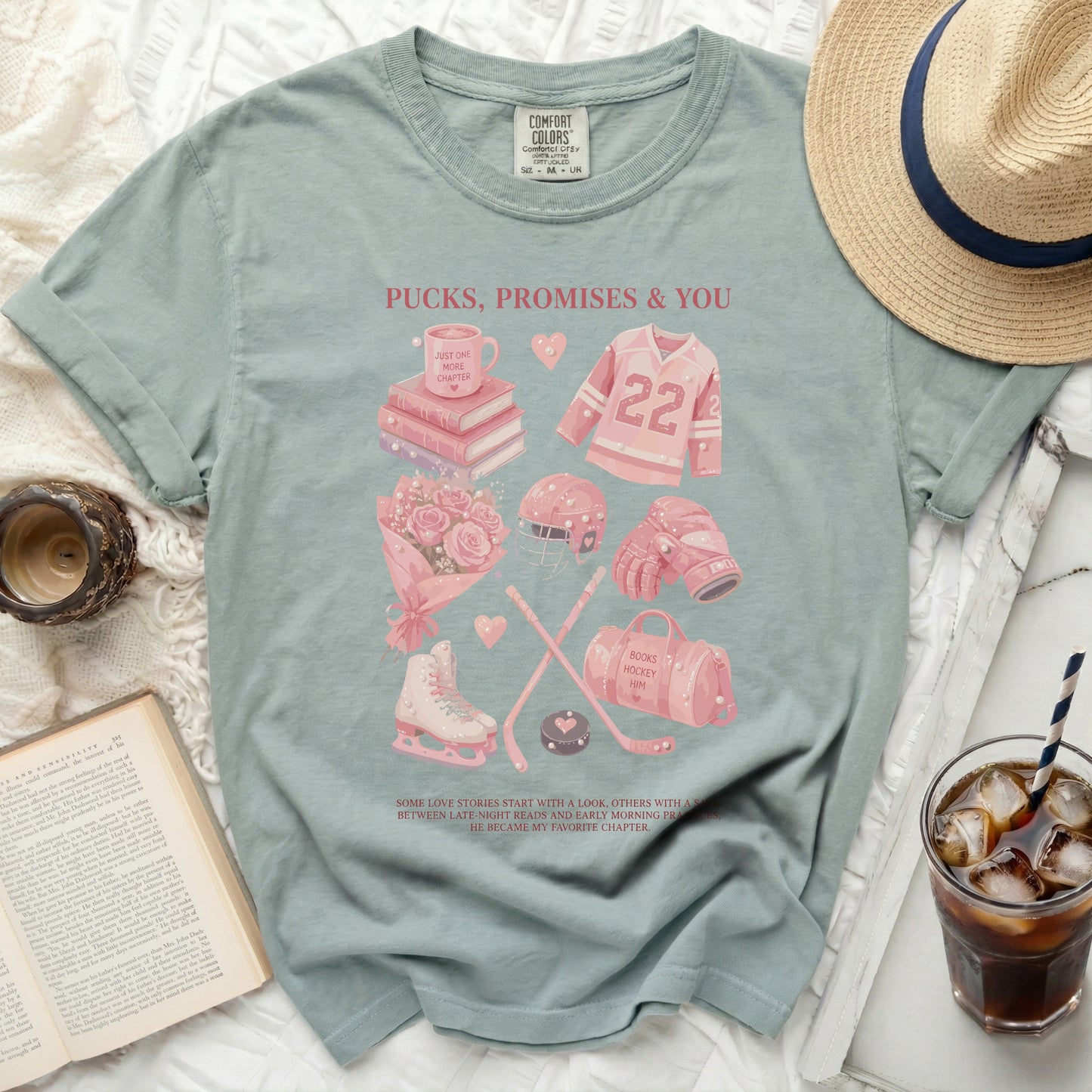 T-shirt with hockey, book, and coffee graphics, text "Pucks, Promises & You".