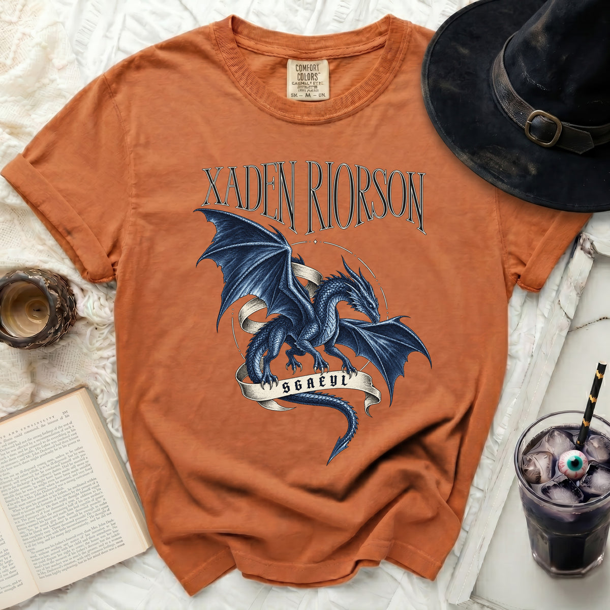 Orange t-shirt with "XADEN RIORSON SGAEYL" text and blue dragon design.