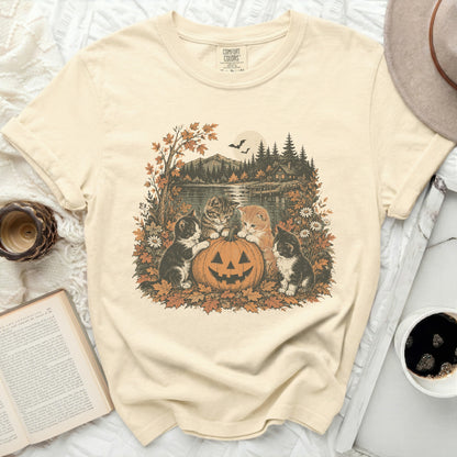 Cream t-shirt with kittens and a jack-o-lantern on an autumn landscape.