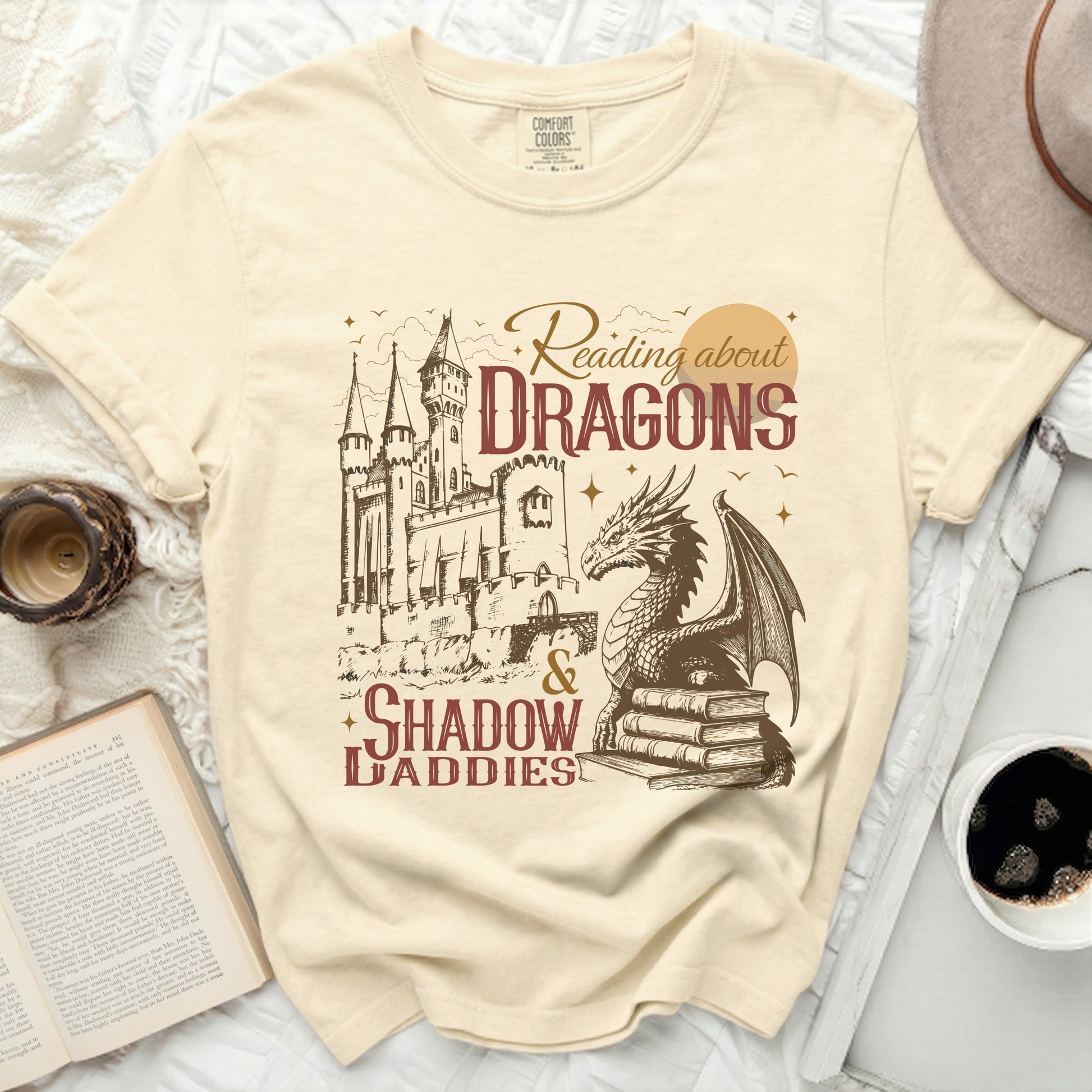 Comfort Colors t-shirt with "Reading about Dragons & Shadow Daddies" graphic.