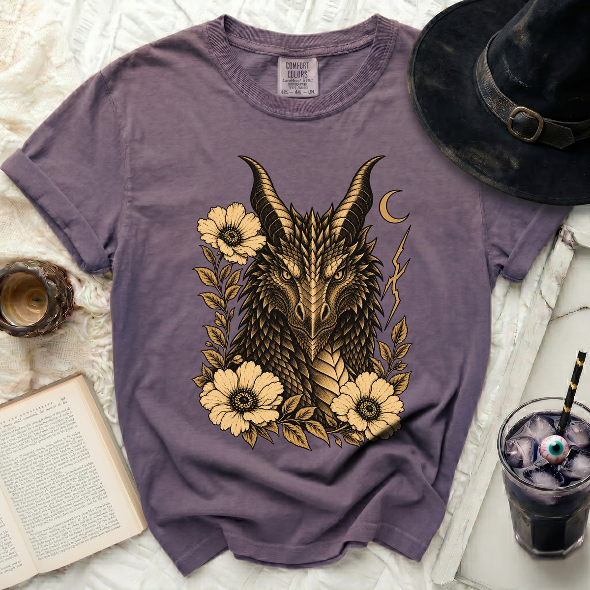 Purple t-shirt with a gold dragon head design surrounded by flowers.