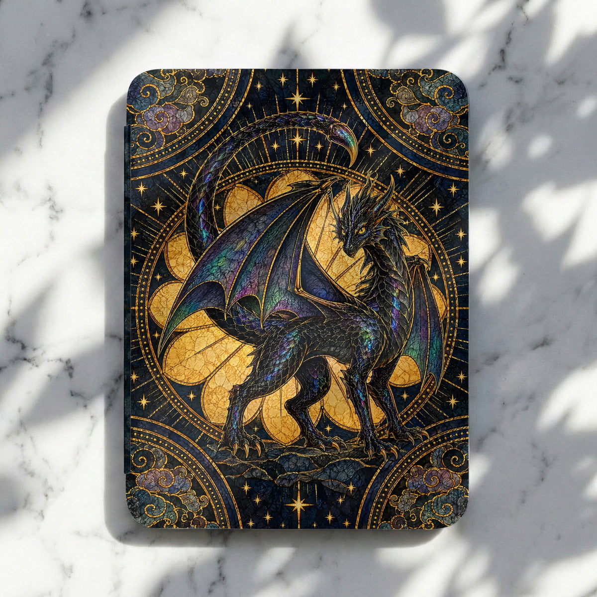 A Kindle cover features an iridescent dragon in a stained-glass style against a starry, golden background.