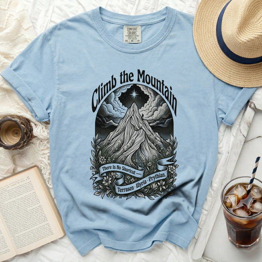 Light blue t-shirt with "Climb the Mountain" graphic and text.