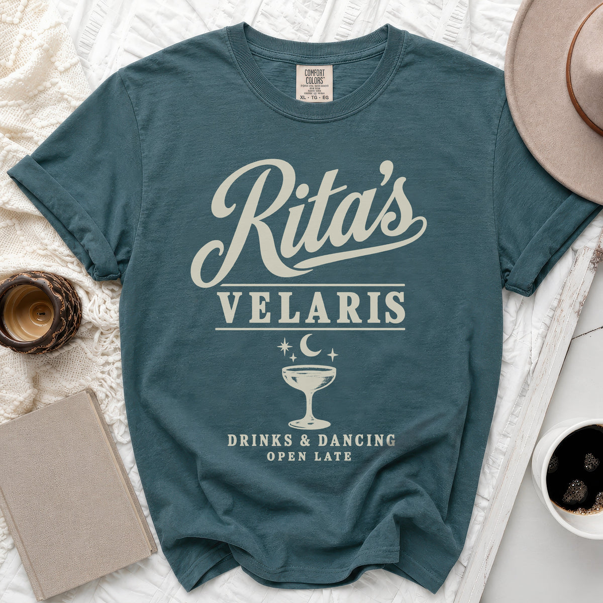 Teal t-shirt with "Rita's Velaris Drinks & Dancing Open Late" text and graphics.