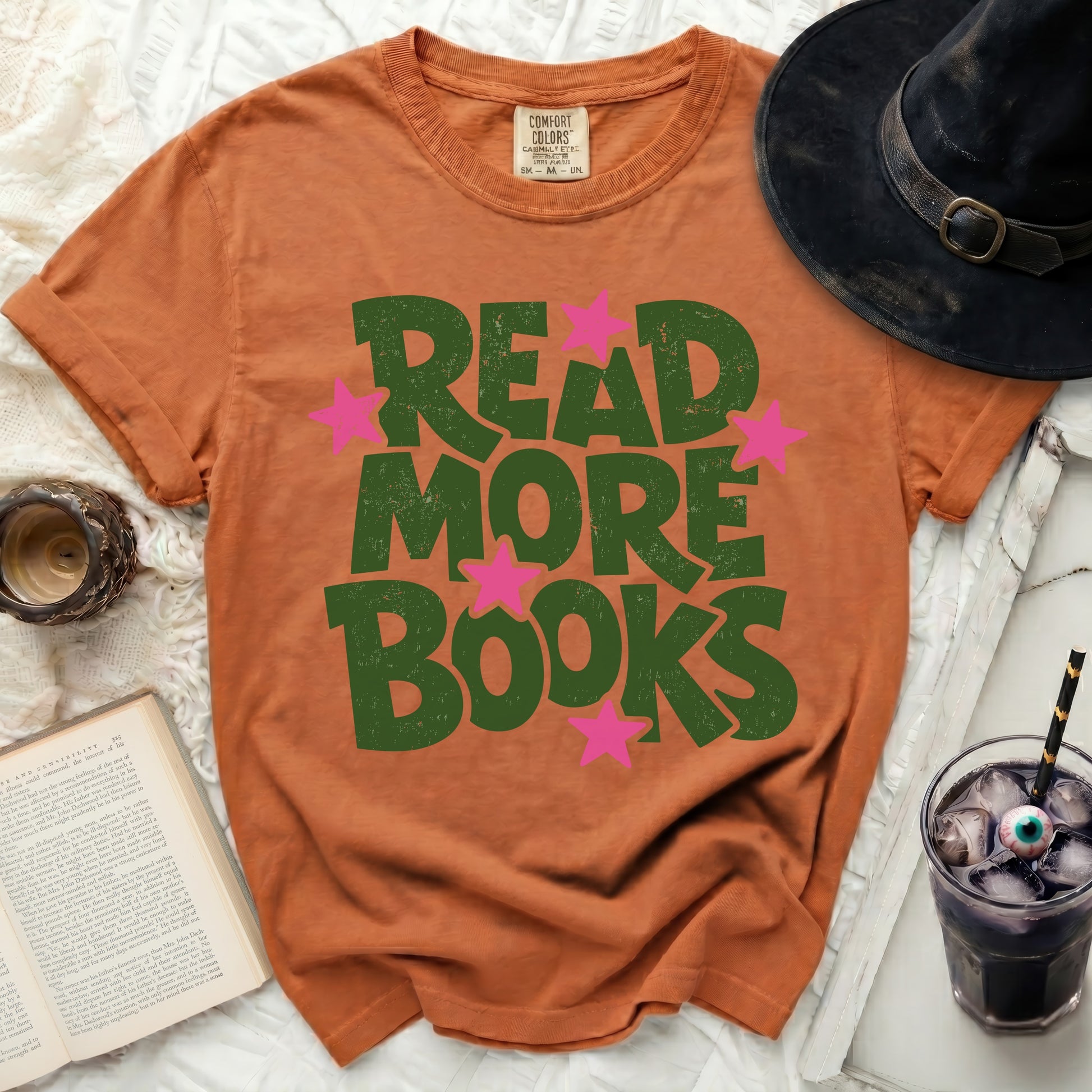 Orange t-shirt with green "READ MORE BOOKS" text and pink stars.
