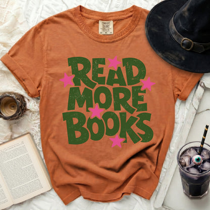 Orange t-shirt with green "READ MORE BOOKS" text and pink stars.
