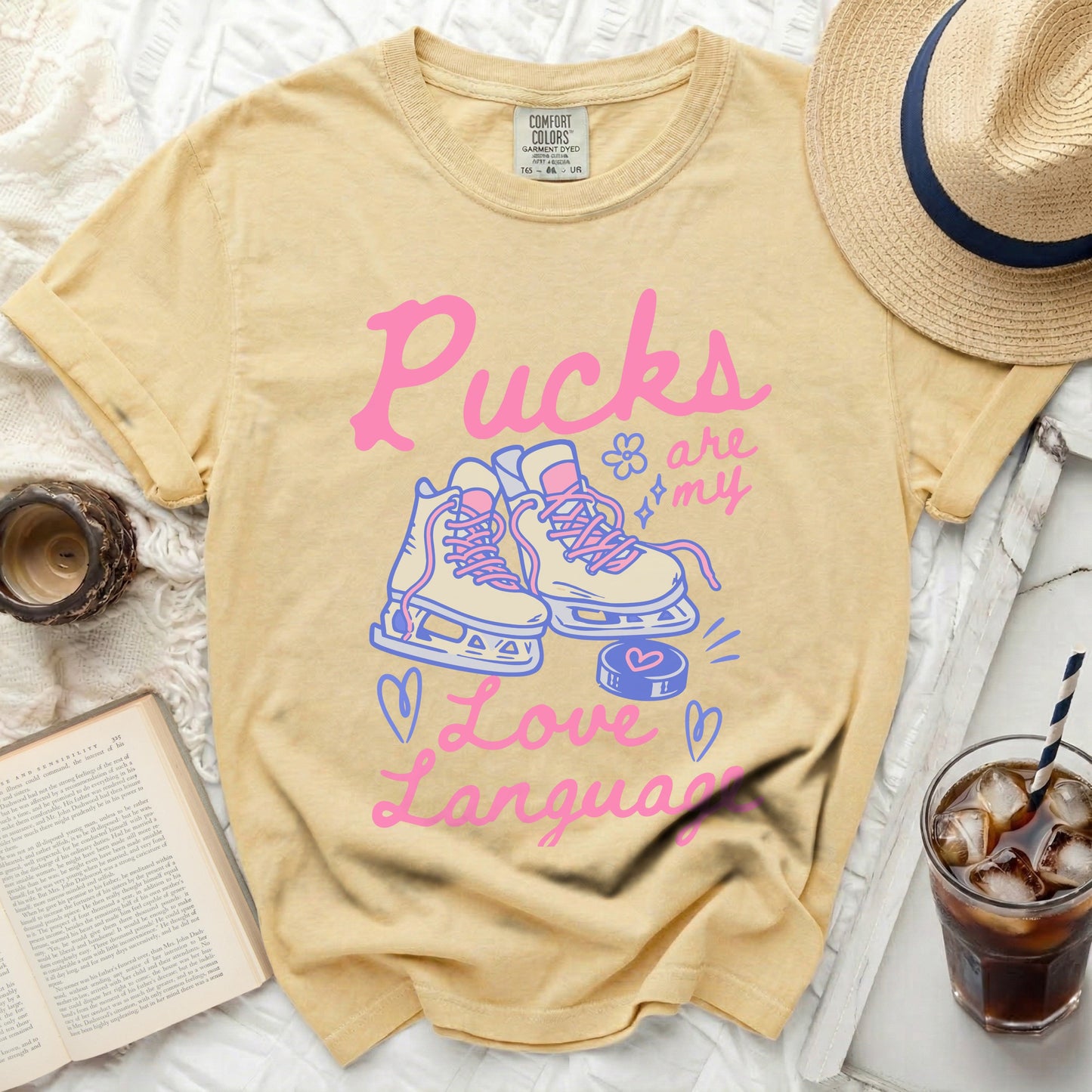 Yellow t-shirt with "Pucks are my Love Language" and ice skates graphic.
