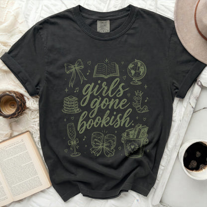 Dark t-shirt with "girls gone bookish" and illustrated books, globes, and champagne.