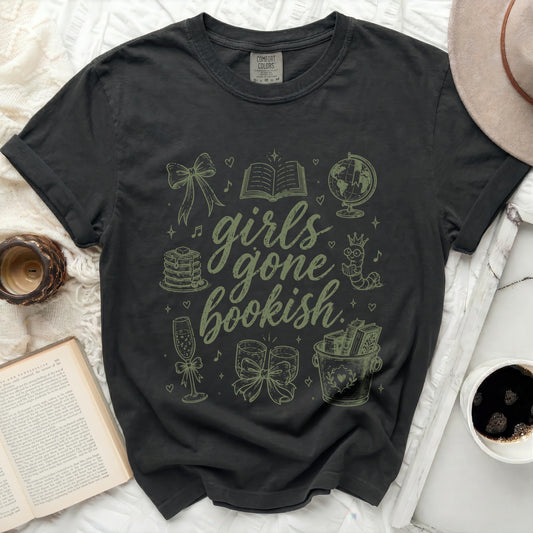 Dark t-shirt with "girls gone bookish" and illustrated books, globes, and champagne.