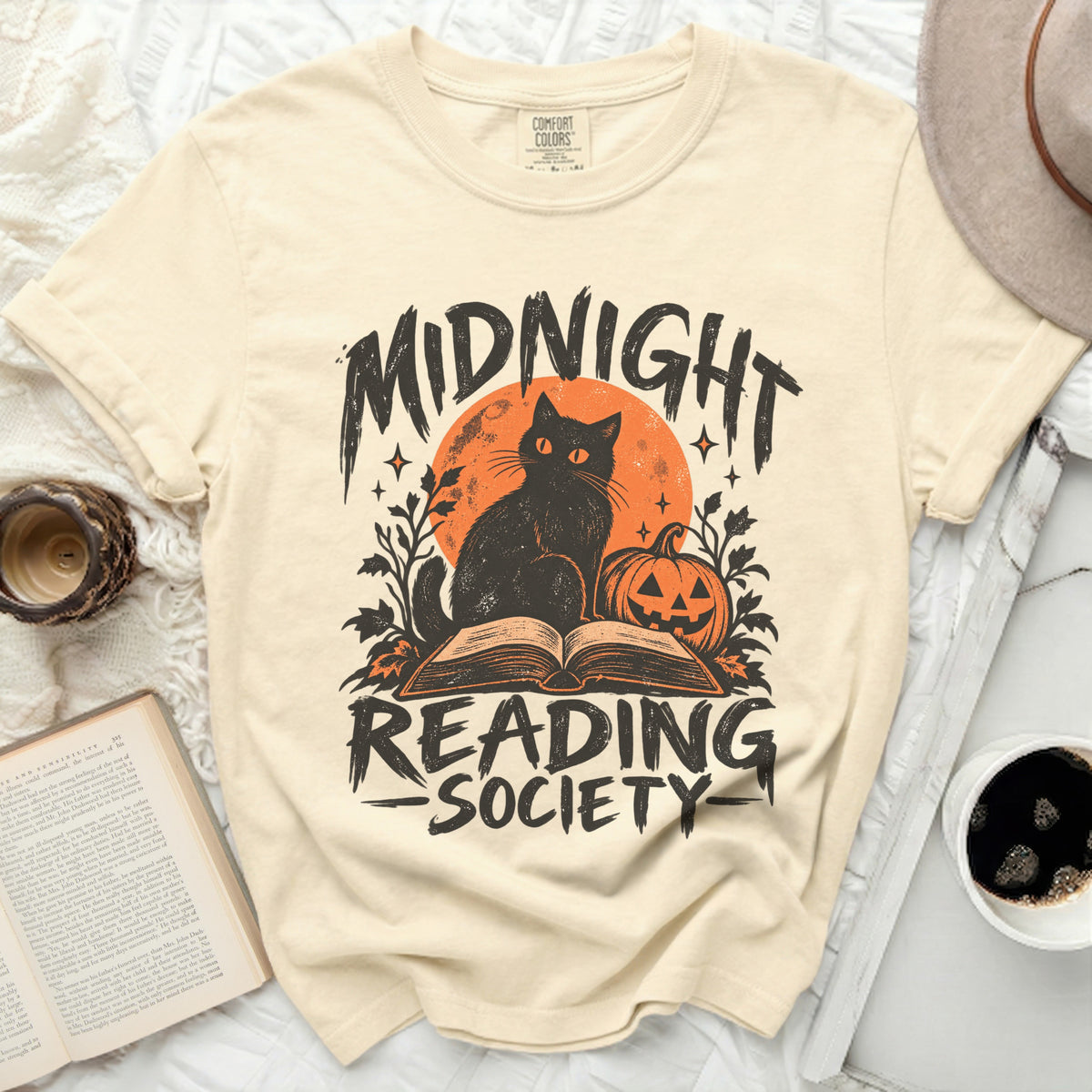 Cream t-shirt with black cat, pumpkin, and text "Midnight Reading Society."