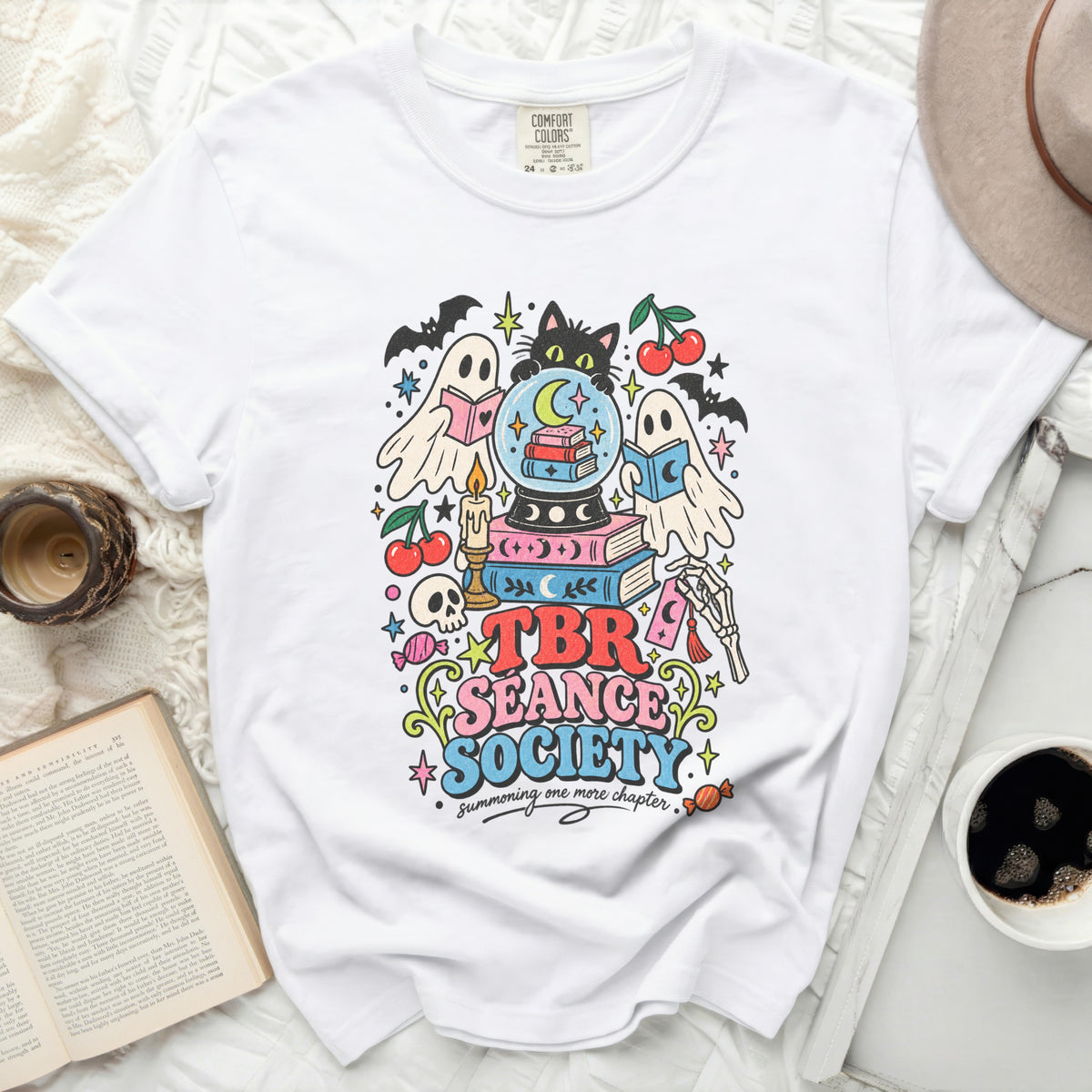 White t-shirt with "TBR Seance Society summoning one more chapter" graphic.