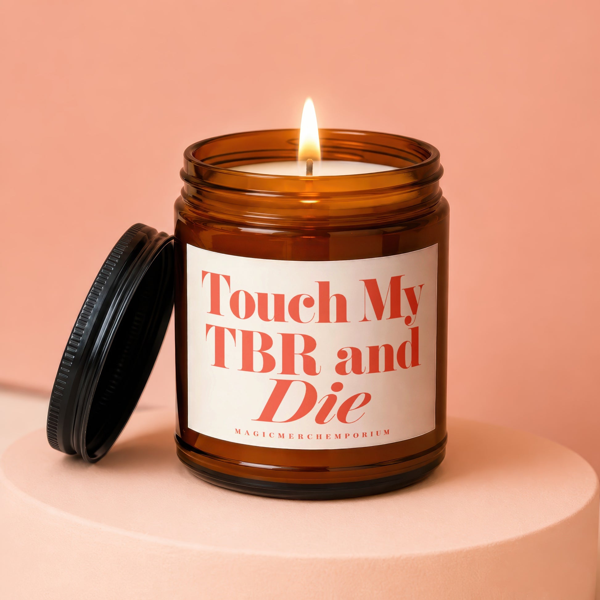 Amber jar candle with lit flame, black lid, and text "Touch My TBR and Die".