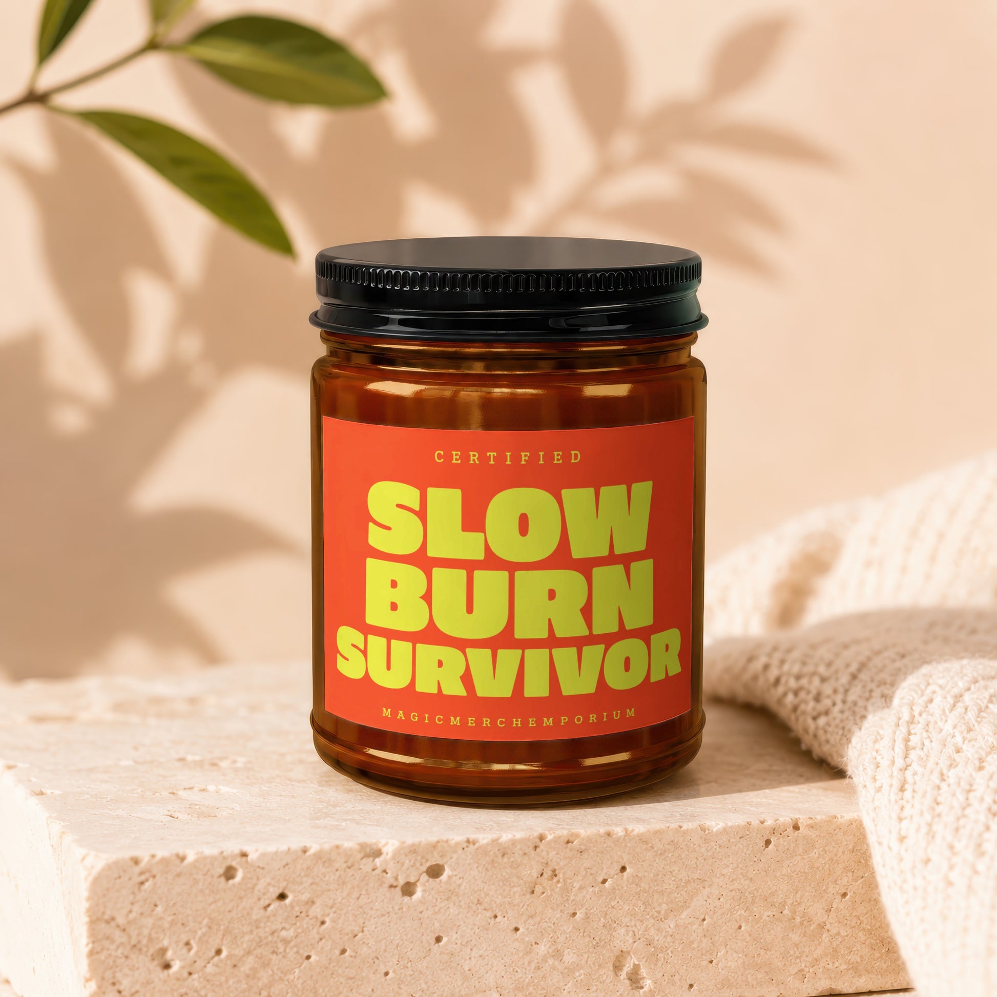 Amber jar with black lid and orange label reading "SLOW BURN SURVIVOR".