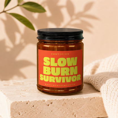 Amber jar with black lid and orange label reading "SLOW BURN SURVIVOR".