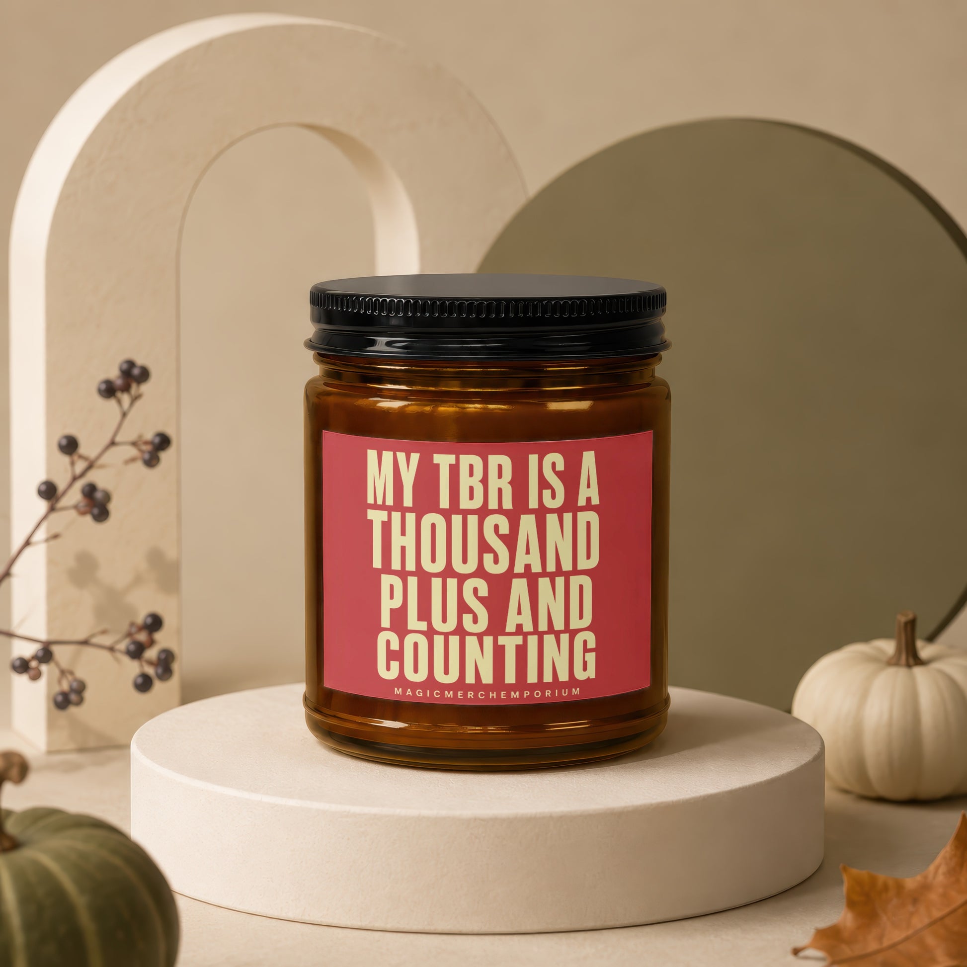 Amber candle with "MY TBR IS A THOUSAND PLUS AND COUNTING" text on pink label.