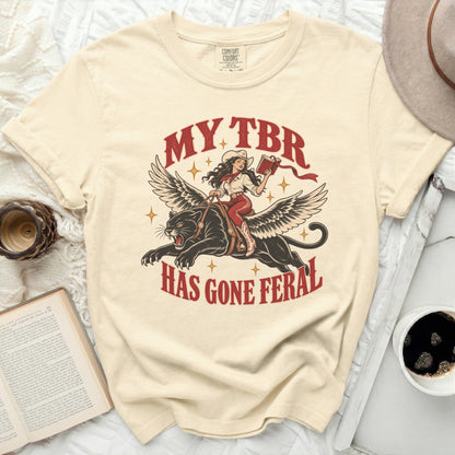 Cream t-shirt with "MY TBR HAS GONE FERAL" text and graphic.