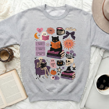 Grey sweatshirt with a collage of Halloween-themed reading graphics.