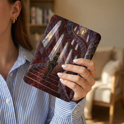 E-reader case with stained glass design of a woman climbing stairs toward a glowing archway.