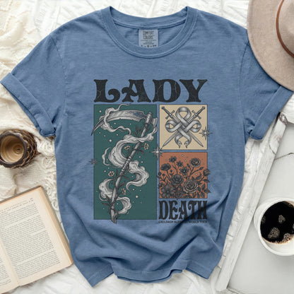 Blue t-shirt with "LADY DEATH" graphic featuring a scythe and flowers.