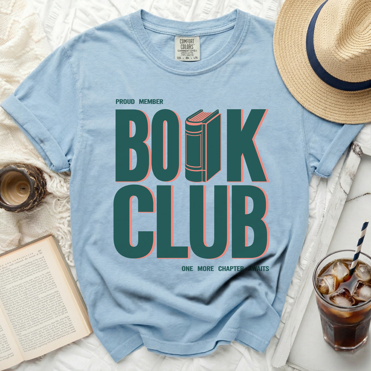 Light blue t-shirt with "Proud Member Book Club" text and an illustration of a book.
