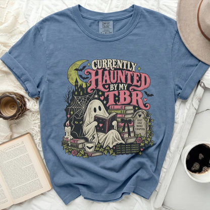 Blue t-shirt with "Currently Haunted By My TBR" ghost and book graphic.