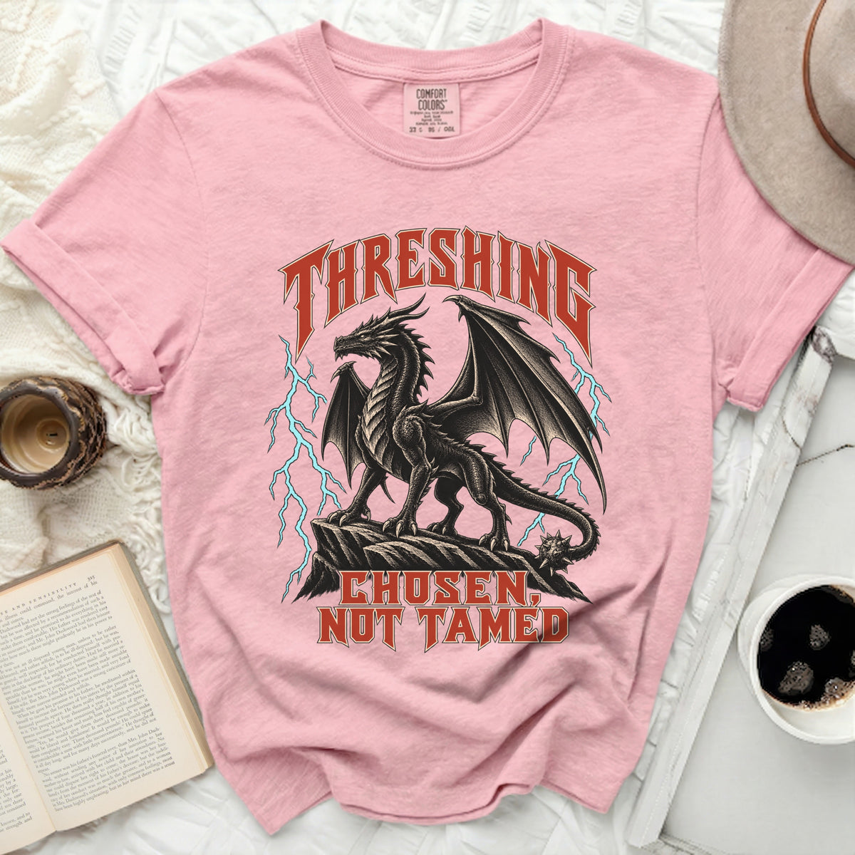 Pink t-shirt with black dragon graphic and text "THRESHING CHOSEN, NOT TAMED".