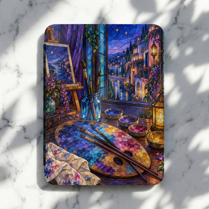 Artist's palette with paints, brushes, easel, and stained glass window view.