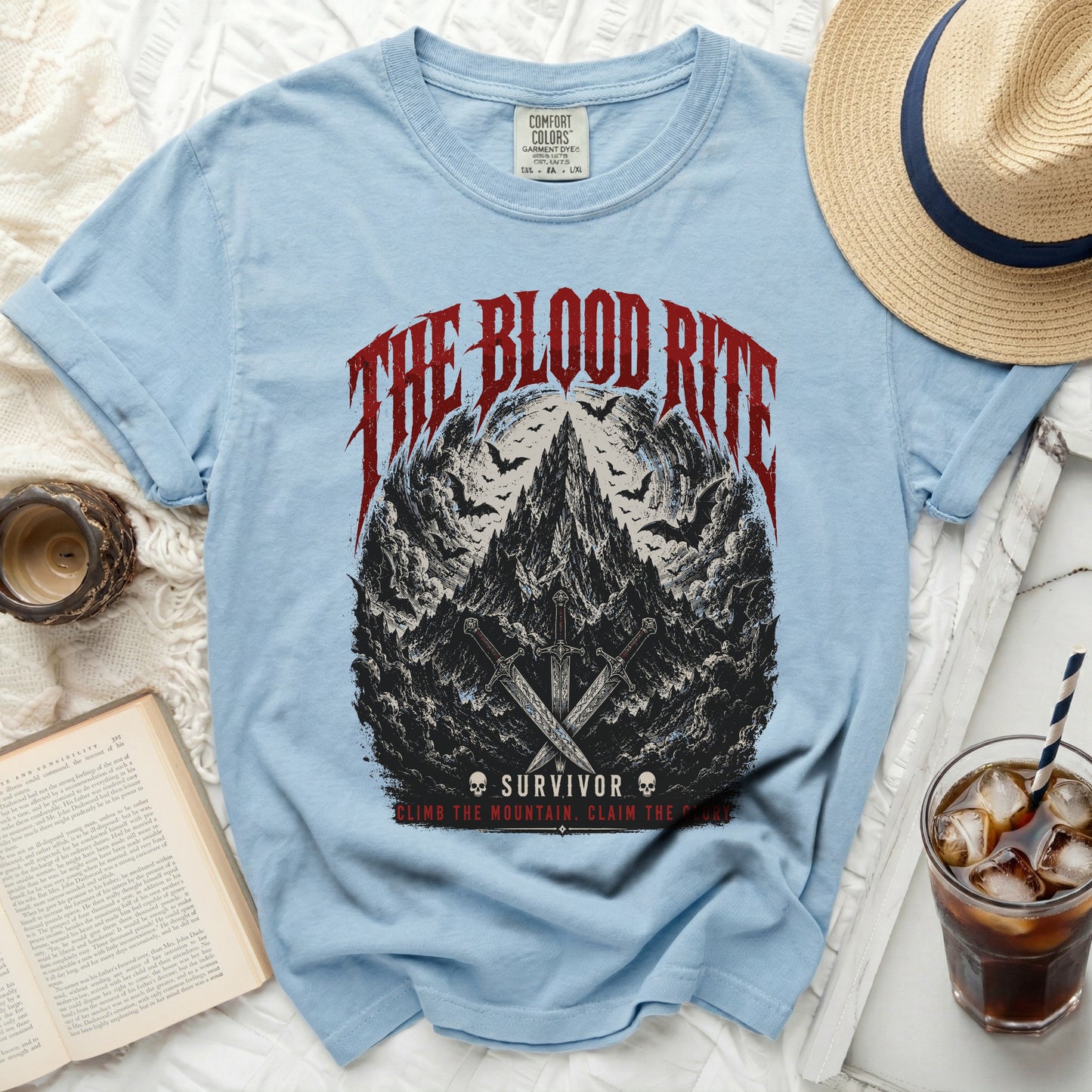 Light blue t-shirt with "The Blood Rite" graphic and swords.