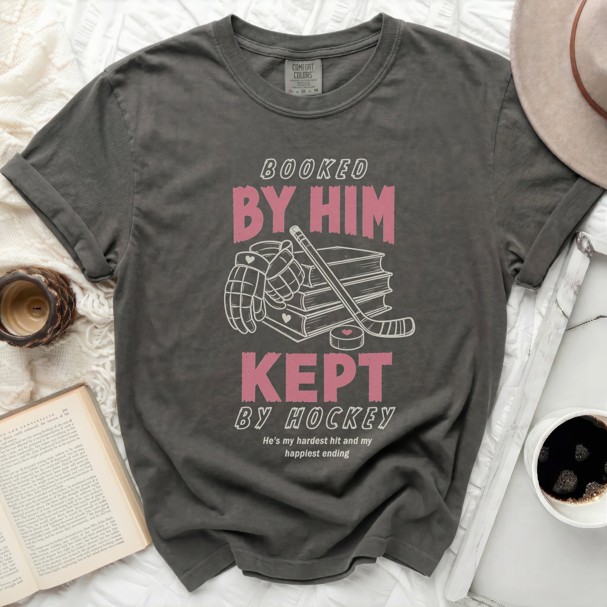 Dark gray t-shirt with "Booked by Him, Kept by Hockey" text.
