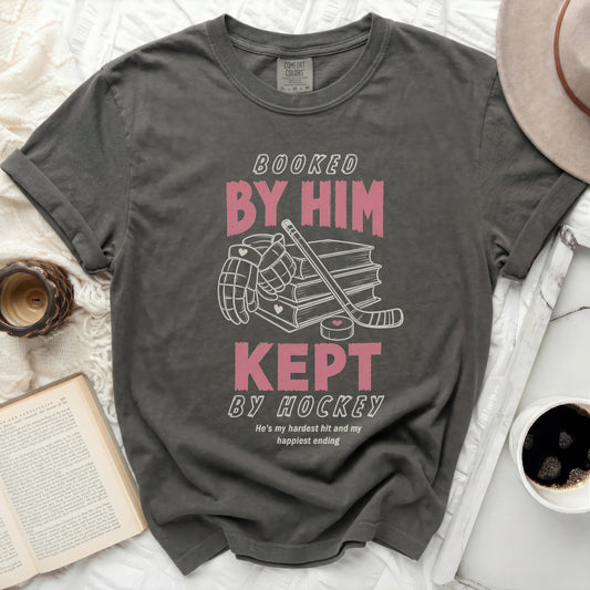 Dark gray t-shirt with "Booked by Him, Kept by Hockey" text.