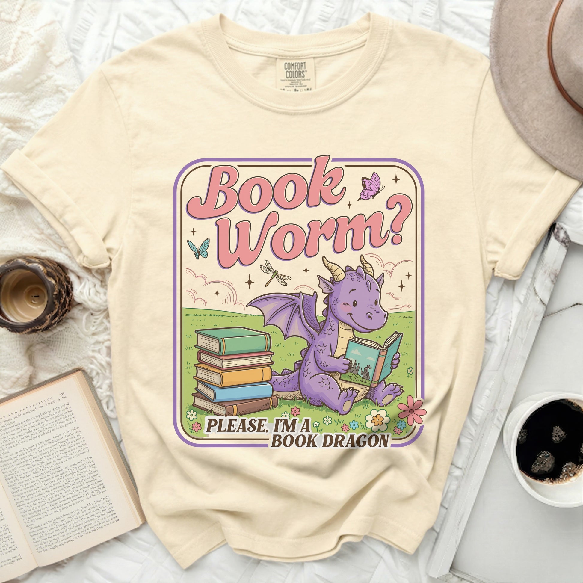 Cream t-shirt with a "Book Worm? Please, I'm a Book Dragon" graphic featuring a dragon reading a book.