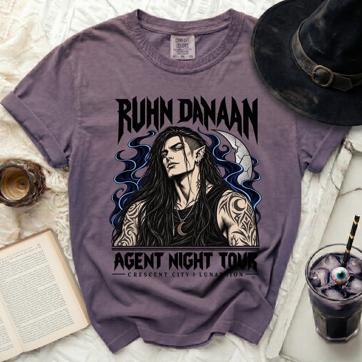 Purple t-shirt with "RUHN DANAAN AGENT NIGHT TOUR" and elf graphic.