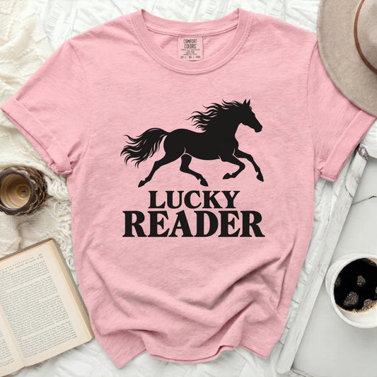 Pink t-shirt with black silhouette of a running horse and text "LUCKY READER".
