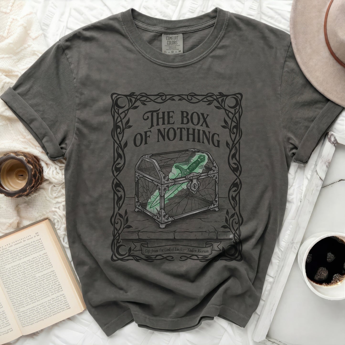 Dark t-shirt with "The Box of Nothing" graphic and treasure chest.