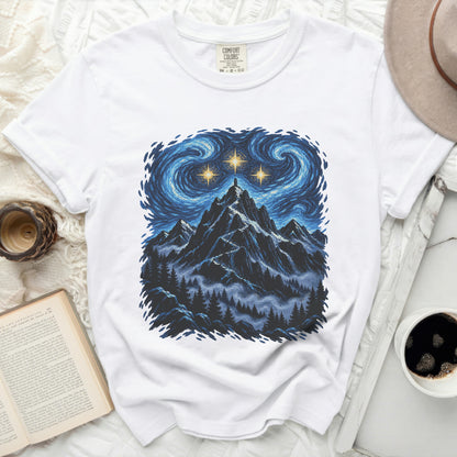 White t-shirt with a starry night mountain landscape graphic and "Comfort Colors" label.