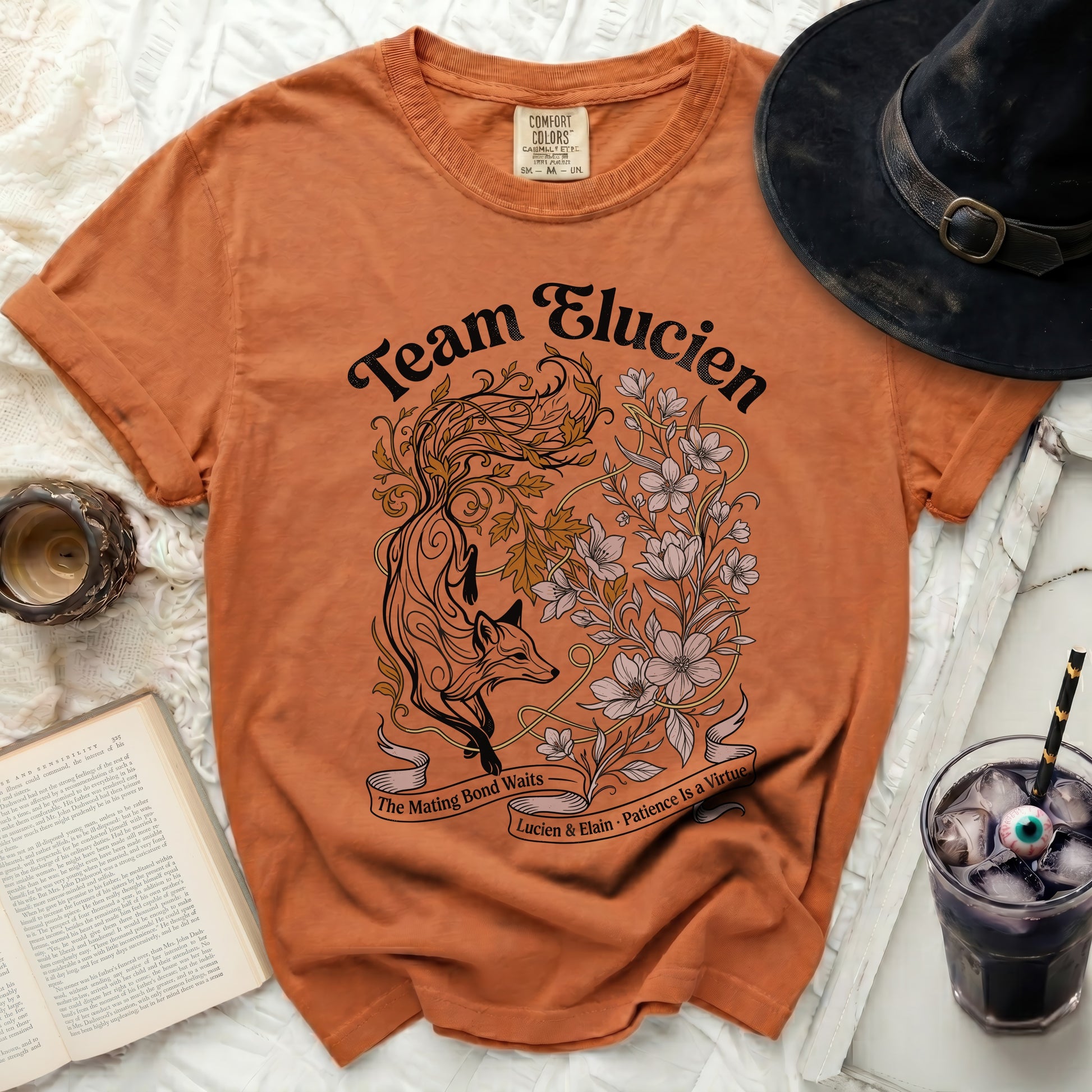 Orange t-shirt with "Team Elucien" and a fox and floral design.