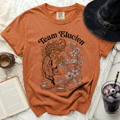 Orange t-shirt with "Team Elucien" and a fox and floral design.