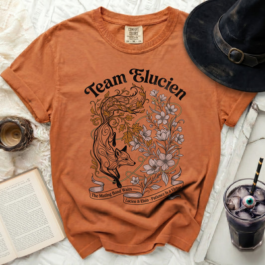 Orange t-shirt with "Team Elucien" and a fox and floral design.