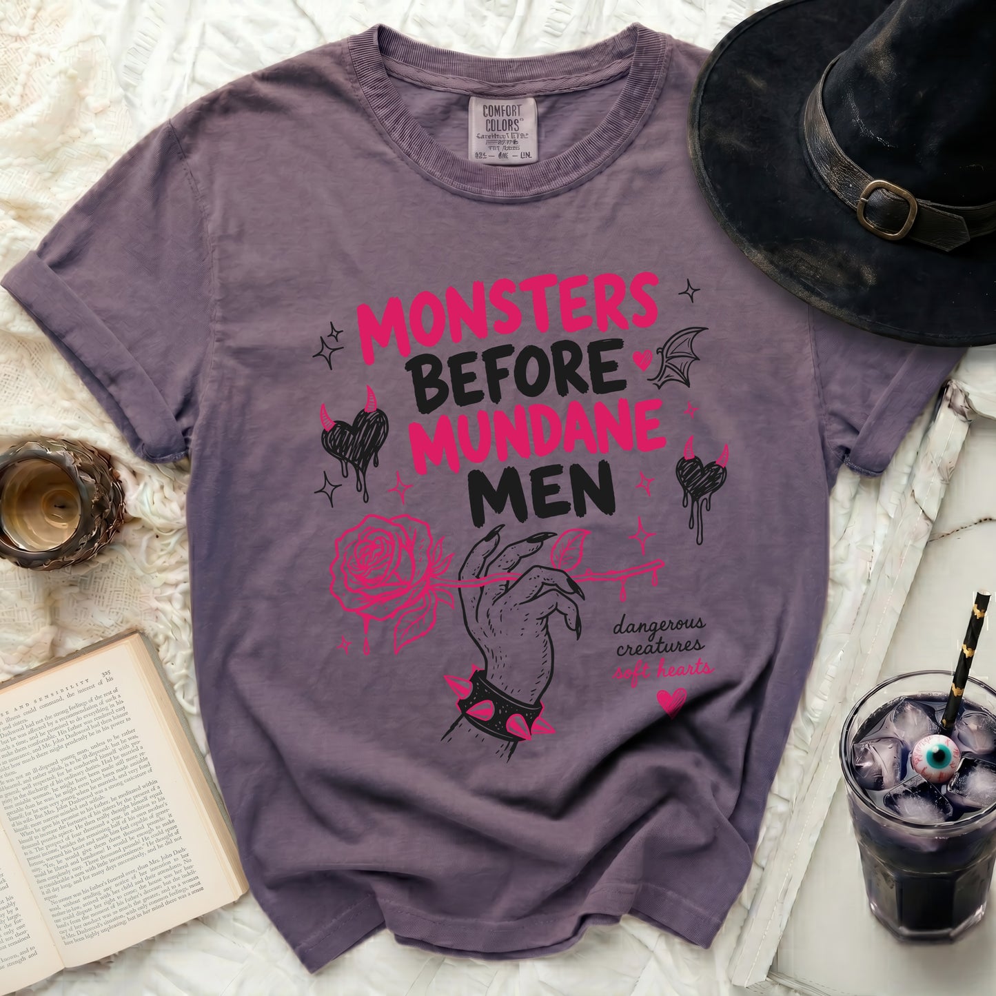 Purple t-shirt with "MONSTERS BEFORE MUNDANE" text and pink graphics.