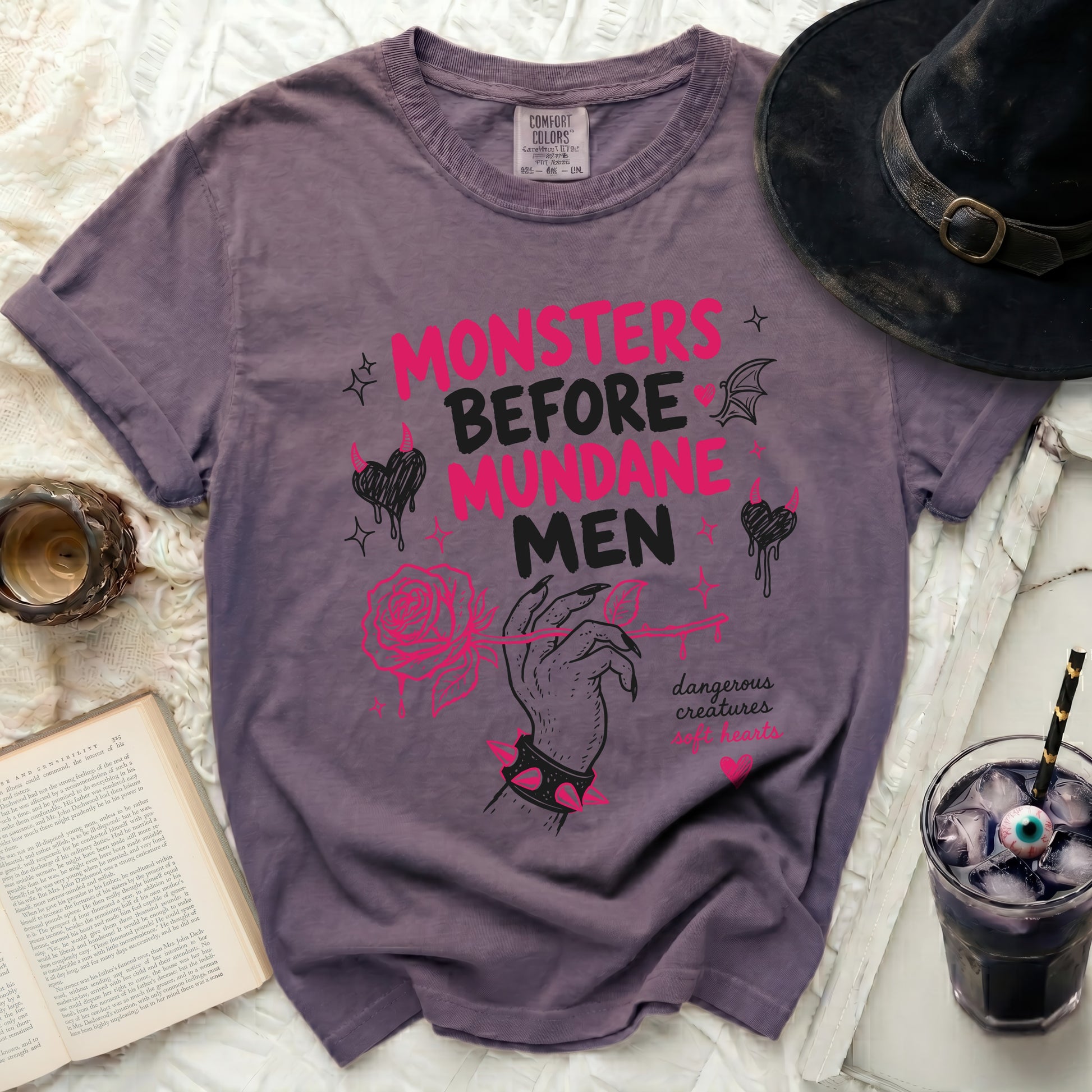 Purple t-shirt with "MONSTERS BEFORE MUNDANE" text and pink graphics.