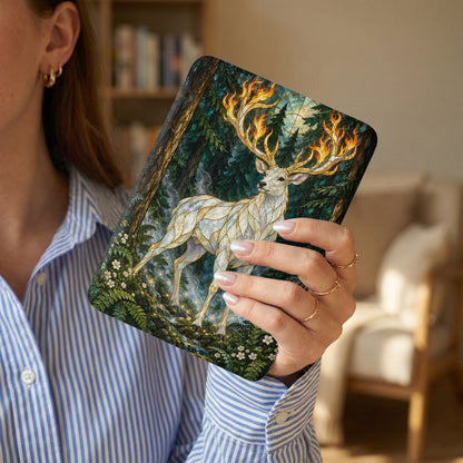 White stag with fiery antlers in a mystical forest scene on a book cover.