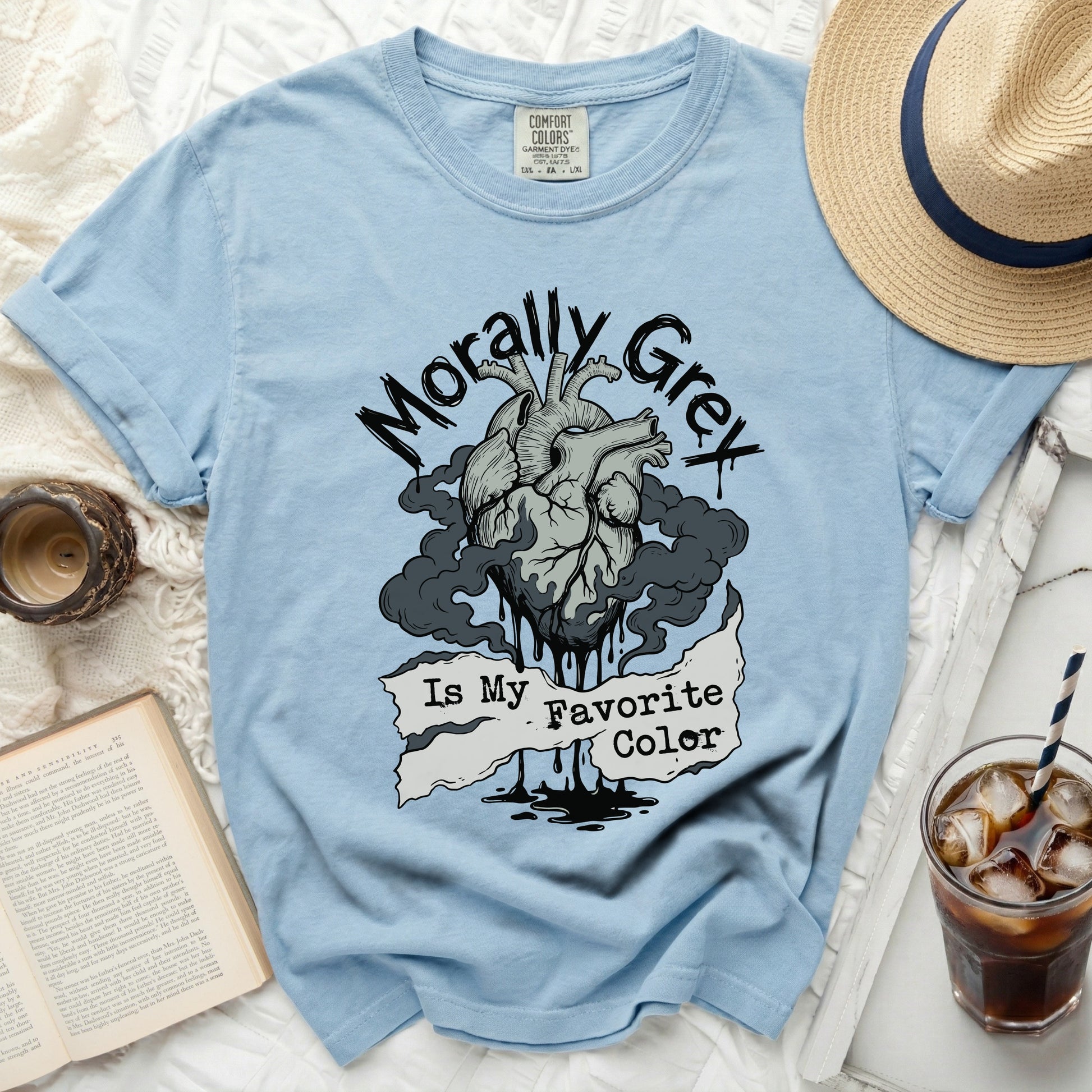 Light blue t-shirt with a graphic of a heart, smoke, and the text "Morally Grey Is My Favorite Color".