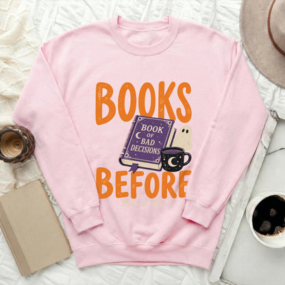 Pink sweatshirt with "Books Before Bad Decisions" graphic featuring a book and ghost.
