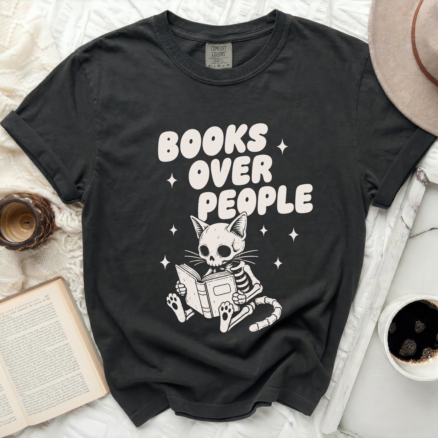 Skeleton cat reading "Books Over People" on dark t-shirt.