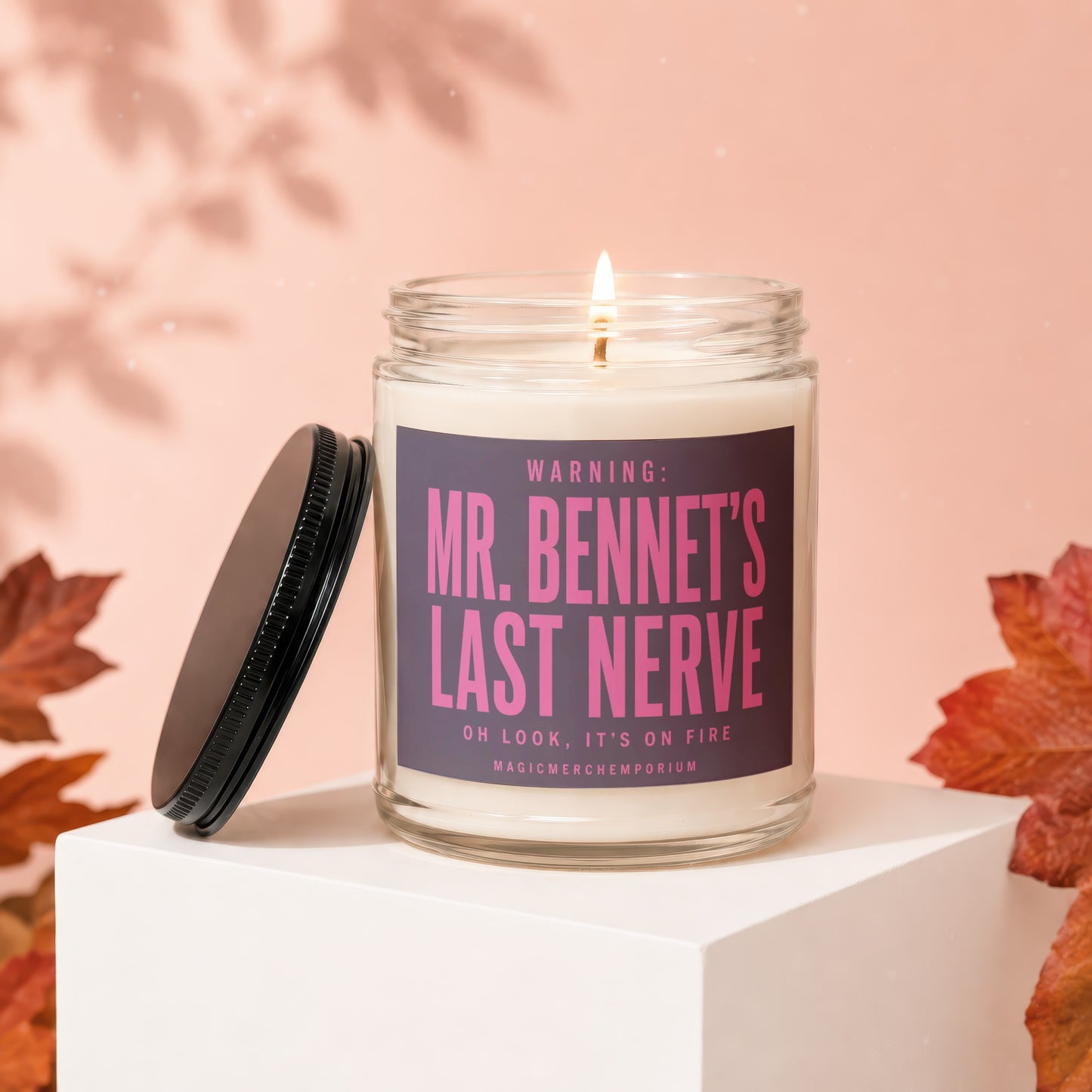 Lit glass candle with dark lid jar labeled "Mr. Bennet's Last Nerve".
