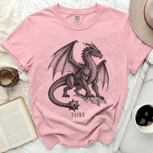 Pink t-shirt with a black dragon graphic and the word "TAIRN".