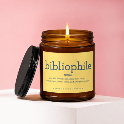 Amber glass candle with lit flame and label defining "bibliophile".