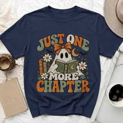 Navy t-shirt with a ghost reading a book and the text "Just One More Chapter".