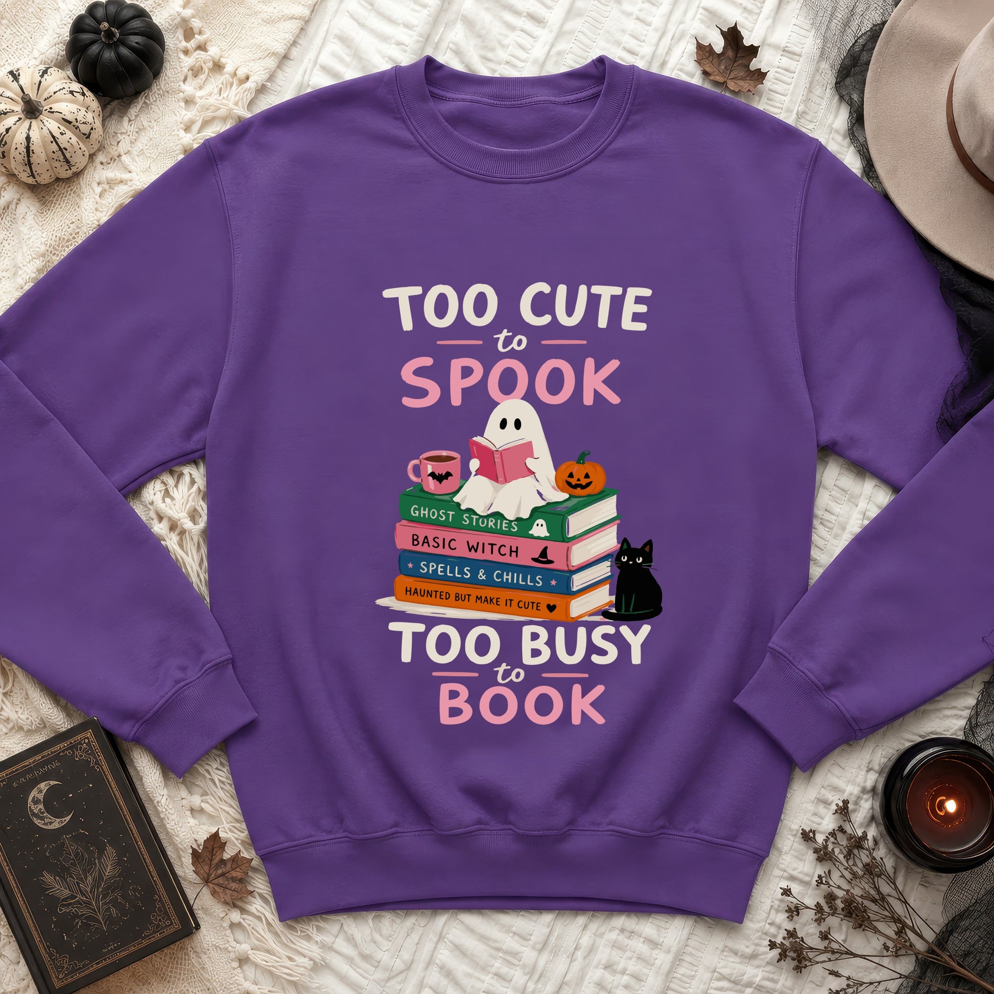 Purple sweatshirt featuring "Too Cute to Spook Too Busy to Book" text and ghost.
