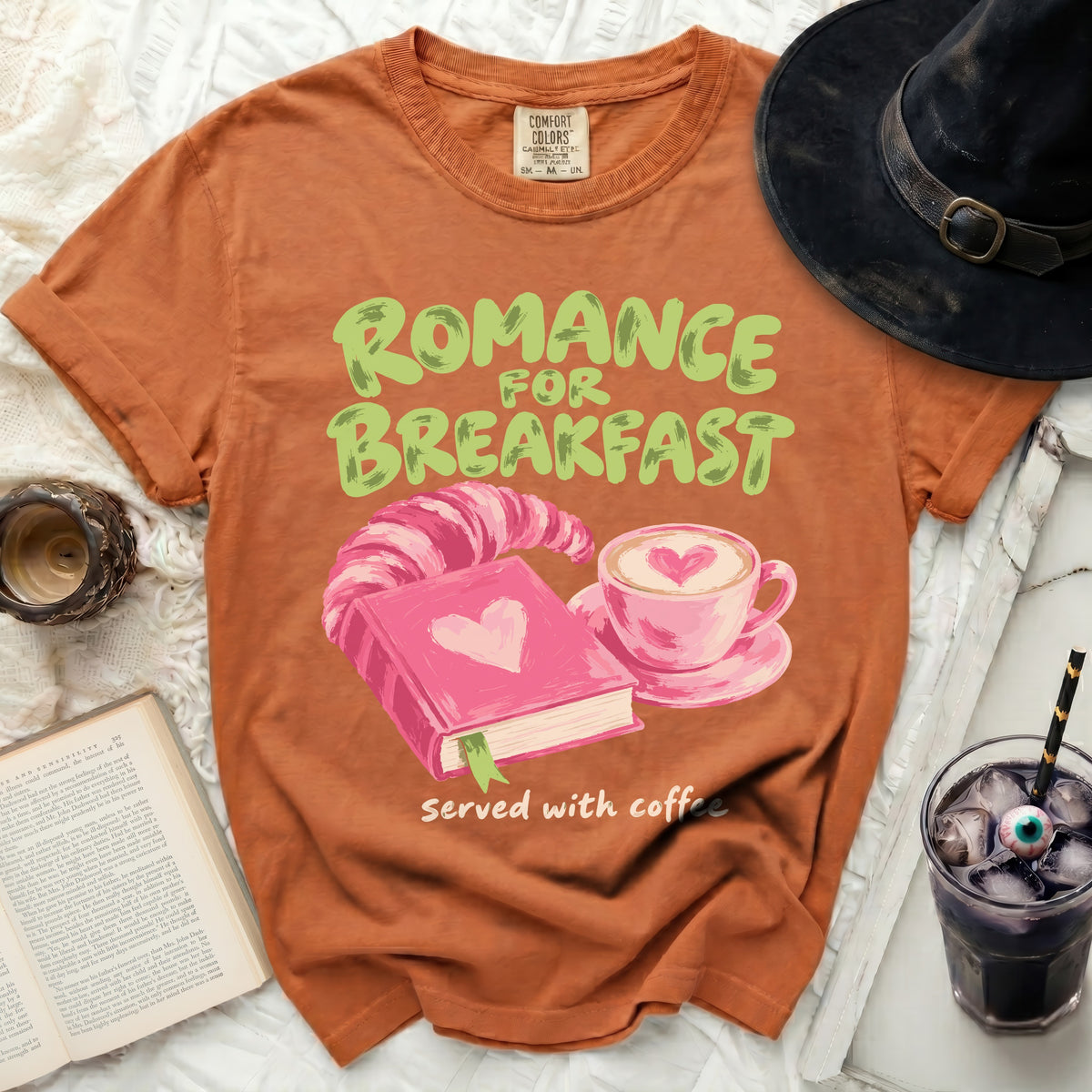 Orange t-shirt with "Romance for Breakfast served with coffee" graphic.